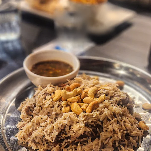 Mandi, smoked rice with lamb, sultanas and cashews